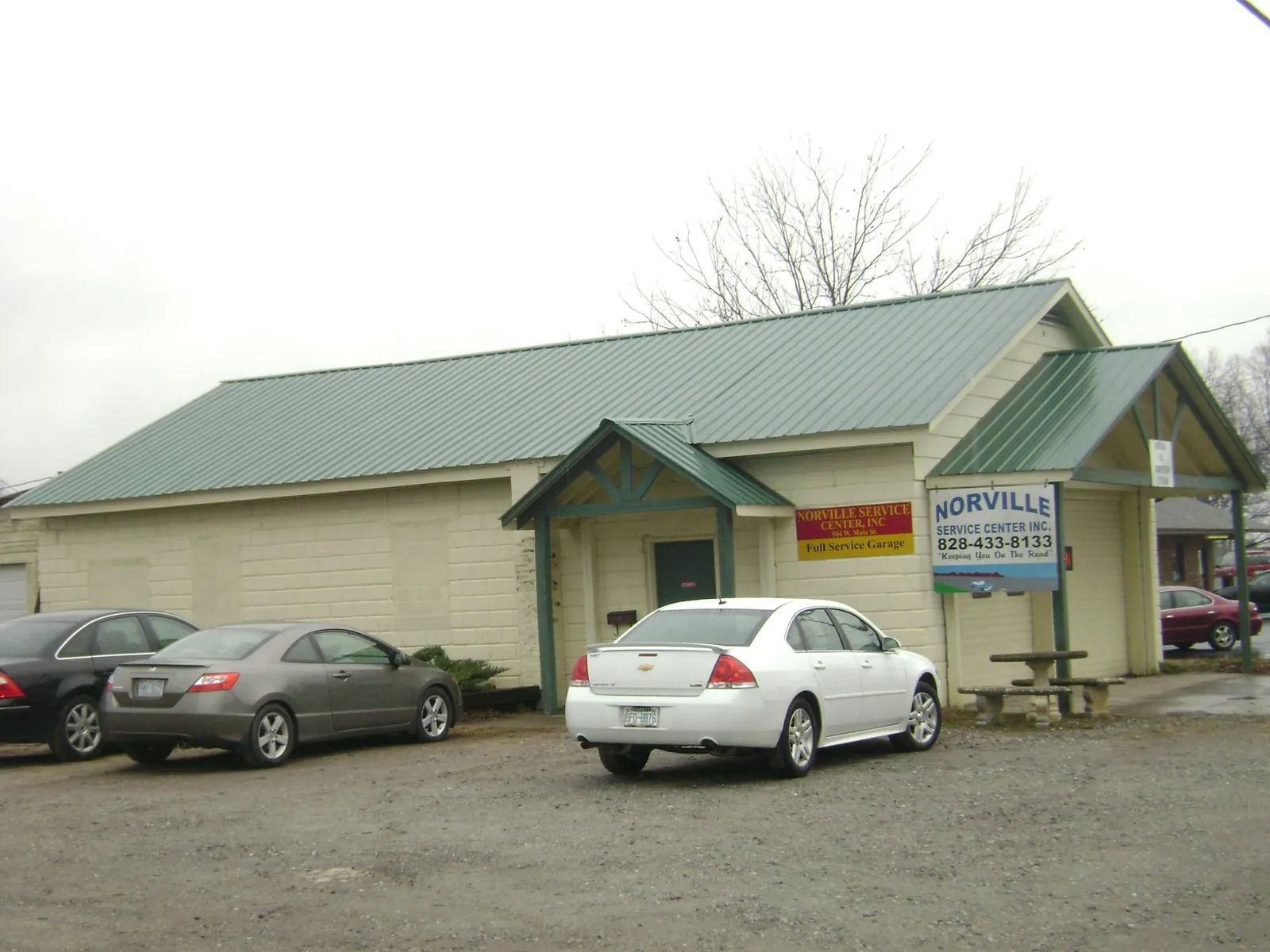 Green metal roof on a service garage with a covered entry in Freeport
